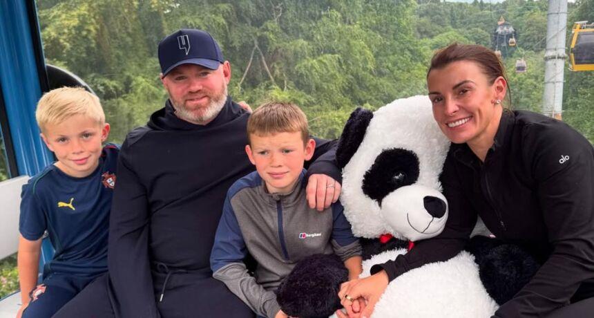 Family time: Wayne Rooney enjoys a day at the amusement park with wife and kids
