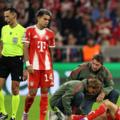 Josip Stanisic of Bayern Munich receives medical treatment during the UEFA Champions League 2025/26