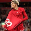 Hugo Ekitike of Liverpool celebrates scoring his team's second goal by removing his match shirt and subsequently receives a second yellow card