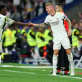 Vinicius Junior of Real Madrid interacts with teammate Toni Kroos of Real Madrid