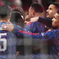 Bukayo Saka of Arsenal (obscured) celebrates scoring his team's first goal with teammates during the UEFA Champions League 2025/26