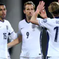 Harry Kane of England celebrates scoring his team's second goal with teammate Morgan Rogers and Anthony Gordon